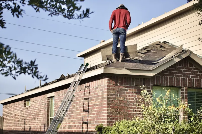 Professional roofer working on a residential roof in Waynesborough Woods